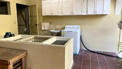 a kitchen with a sink and a stove at Chalchuapa’s Haven in Chalchuapa