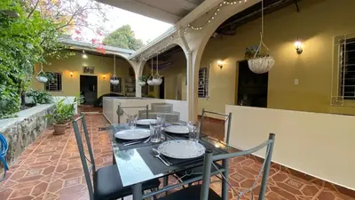 a dining table and chairs on a patio at Chalchuapa’s Haven in Chalchuapa