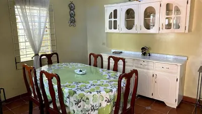 a kitchen with a table and a table and chairs at Chalchuapa’s Haven in Chalchuapa