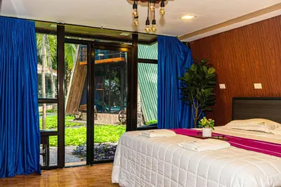 a bedroom with a bed with blue drapes at Hacienda Rubí Club & Resort in San Miguel