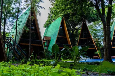 a group of triangular houses with a green roof at Hacienda Rubí Club & Resort in San Miguel