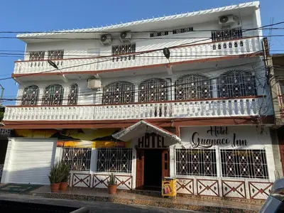 a white building with balconies on the side of it at Hotel Inn El Guanaco in San Miguel