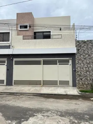 a house with two garage doors on a street at New home in Santa Ana in Santa Ana