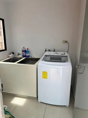 a washer and dryer in a corner of a kitchen at New home in Santa Ana in Santa Ana