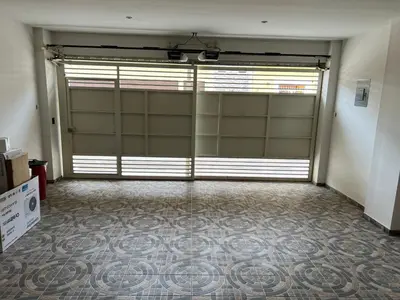 a large garage with two garage doors and a tile floor at New home in Santa Ana in Santa Ana