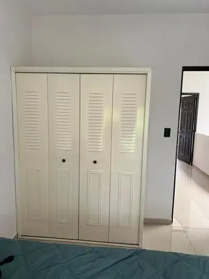 a closet with white doors in a room at New home in Santa Ana in Santa Ana