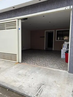 an empty garage with a door and a building at New home in Santa Ana in Santa Ana