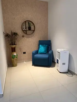 a room with a blue chair and a cpu at New home in Santa Ana in Santa Ana