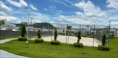 a park with a fence and a tennis court at Gabby House in Sitio del Niño