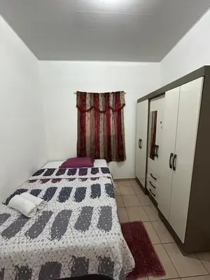 a bedroom with a bed and a window at Gabby House in Sitio del Niño