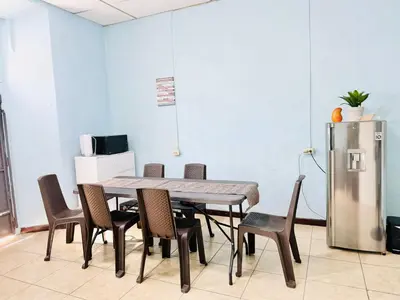 a dining room with a table and chairs and a refrigerator at Santa Ana, Close to Cathedral in Santa Ana