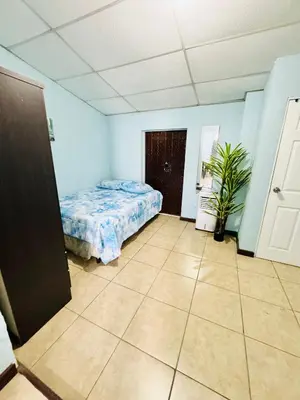 a bedroom with a bed and a tile floor at Santa Ana, Close to Cathedral in Santa Ana