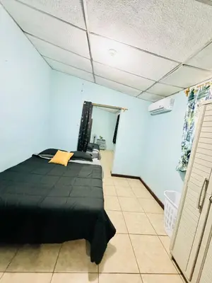 a bedroom with a black bed in a room at Santa Ana, Close to Cathedral in Santa Ana