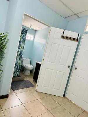 a bathroom with a toilet and a white door at Santa Ana, Close to Cathedral in Santa Ana