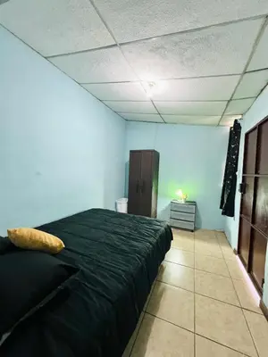 a bedroom with a black bed in a room at Santa Ana, Close to Cathedral in Santa Ana
