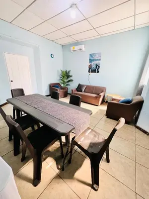 a living room with a table and chairs and a couch at Santa Ana, Close to Cathedral in Santa Ana