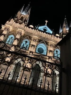 a building with a cross on top of it at night at Santa Ana, Close to Cathedral in Santa Ana