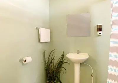 a bathroom with a sink and a mirror at Las Terrazas de el Alto in Chalatenango