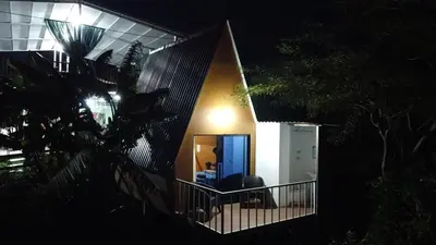 a house with a balcony at night at Las Terrazas de el Alto in Chalatenango