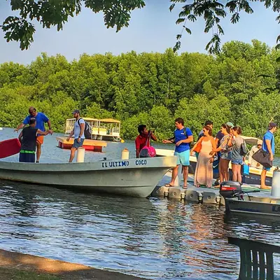 a group of people on a boat in the water at Puerto Barillas in Bahia de Jiquilisco