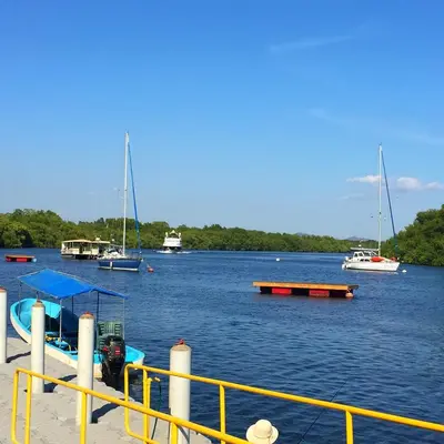 a group of boats floating on a large body of water at Puerto Barillas in Bahia de Jiquilisco