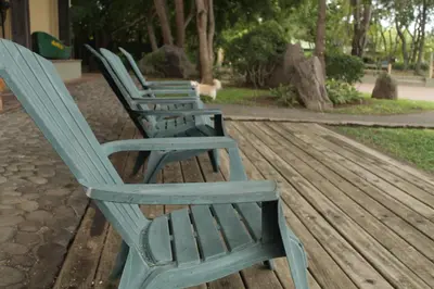a row of blue chairs sitting on a wooden deck at Puerto Barillas in Bahia de Jiquilisco