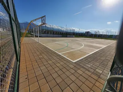 a tennis court with a net and a basketball hoop at Apartamento Familiar in Santa Ana