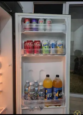an open refrigerator filled with lots of drinks at Apartamento Familiar in Santa Ana
