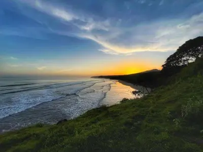 a view of a beach with the sunset in the background at Surf Lodge El Carrizal-Punta Mango in La Periquera