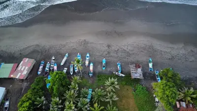 an aerial view of a beach with boats in the water at Surf Lodge El Carrizal-Punta Mango in La Periquera
