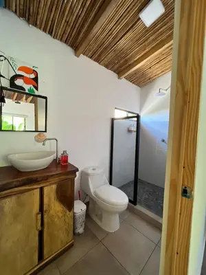 a bathroom with a toilet and a sink and a shower at Surf Lodge El Carrizal-Punta Mango in La Periquera