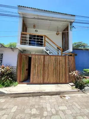 a house with a wooden gate in front of it at Wayo loft en Playa El Tunco Surf City in Tamanique