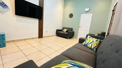 a living room with a couch and a flat screen tv at Muy cerca de playas y miradores muy accesible a la ciudad y comercios in La Unión