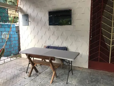 a ping pong table in front of a wall at Hostal Tia Reyna in El Zonte