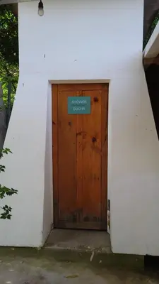 a wooden door with a sign on it at Hostal Tia Reyna in El Zonte