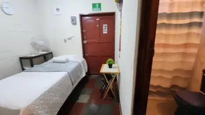 a small room with two beds and a red door at D Origen House APANECA in Apaneca