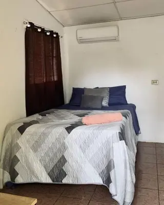 a bedroom with a large bed in a room at Casa Maracuyá in La Libertad