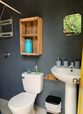 a bathroom with a toilet and a sink at Casa Maracuyá in La Libertad