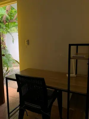 a wooden table with a chair in a room at Casa Maracuyá in La Libertad