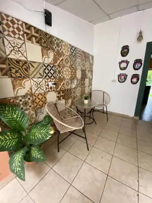 a room with a table and chairs and a plant at Terrazas Guest House-Hostal in Suchitoto