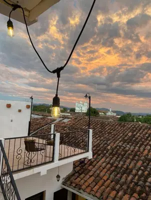 a balcony with a chair on the roof of a building at Terrazas Guest House-Hostal in Suchitoto