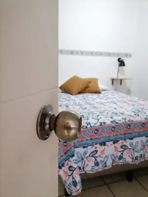 a bedroom with a bed and a door with a door knob at Terrazas Guest House-Hostal in Suchitoto