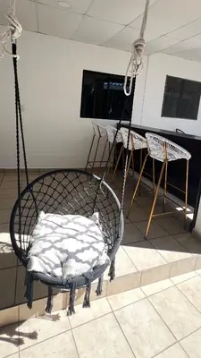 a room with a swing and a table and a television at Terrazas Guest House-Hostal in Suchitoto