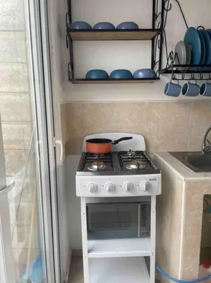 a kitchen with a stove with a pot on it at Tiny but cozy home in Santa Ana in Santa Ana