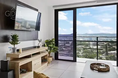 a living room with a view of a city at Modern apt with stunning city and mountain views in San Salvador