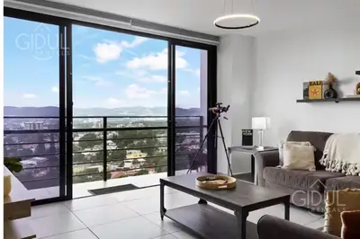 a living room with a view of a city at Modern apt with stunning city and mountain views in San Salvador