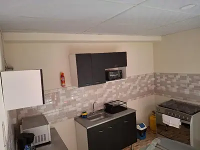 a small kitchen with a sink and a microwave at Casa Centro Histórico Santa Ana in Santa Ana