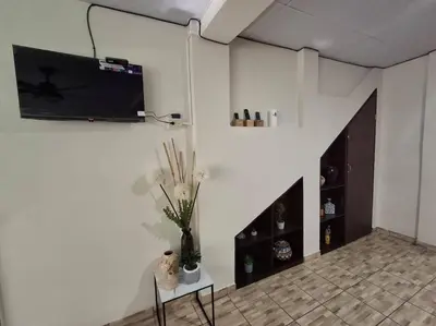a living room with a tv on a white wall at Casa Centro Histórico Santa Ana in Santa Ana