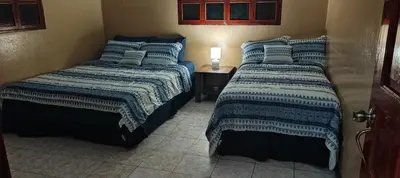 two beds sitting next to each other in a bedroom at El Paraíso Escondido in San Luis