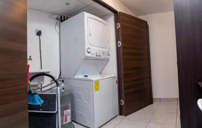 a laundry room with a washer and dryer in it at Condo 9, San Francisco Tower in San Salvador